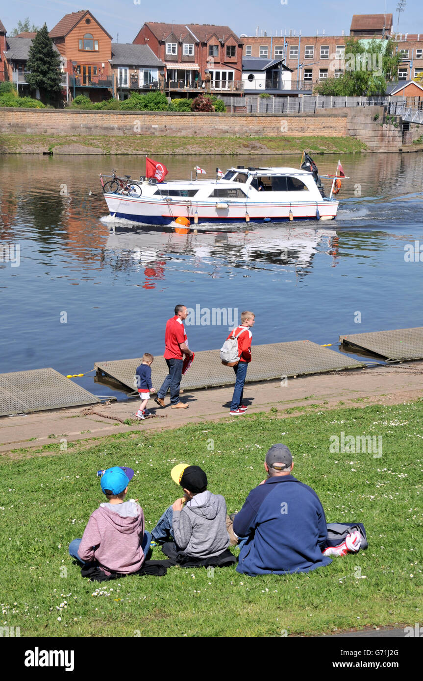 Les fans se détournent vers un bateau sur la rivière Trent portant un drapeau de la forêt de Nottingham, à l'extérieur de la ville Ground, à Nottingham, lors du dernier match à domicile de la saison Banque D'Images