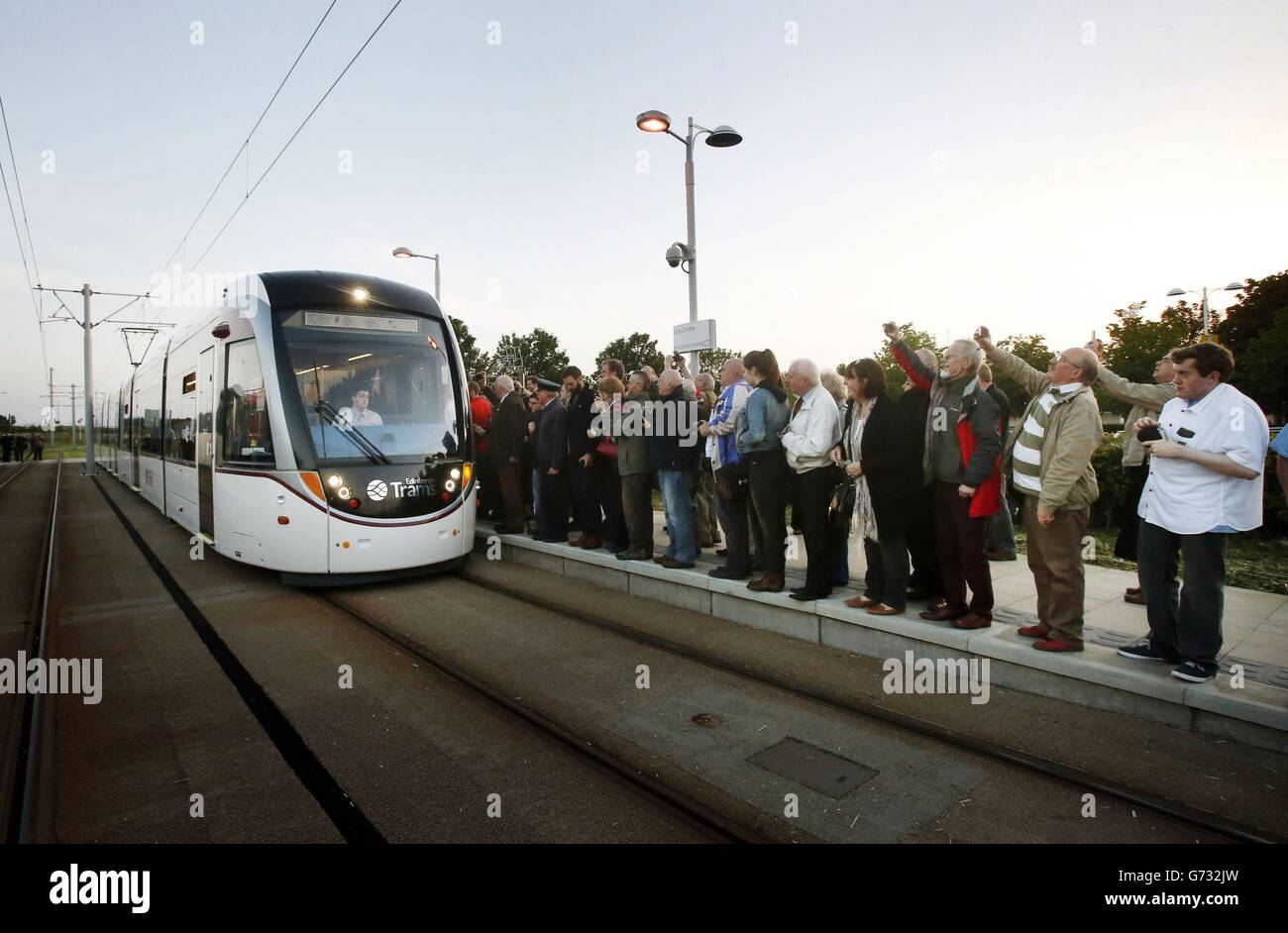 Les premiers passagers payants attendent d'embarquer dans un tramway au centre commercial Gyle d'Édimbourg. Banque D'Images