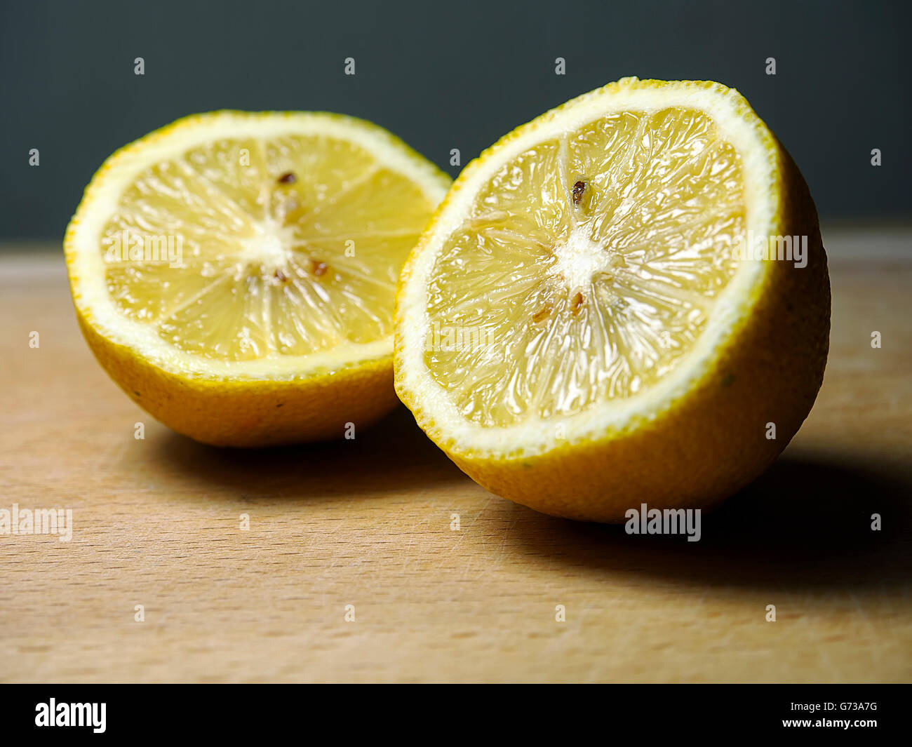 Couper le citron sur une planche de bois. Banque D'Images