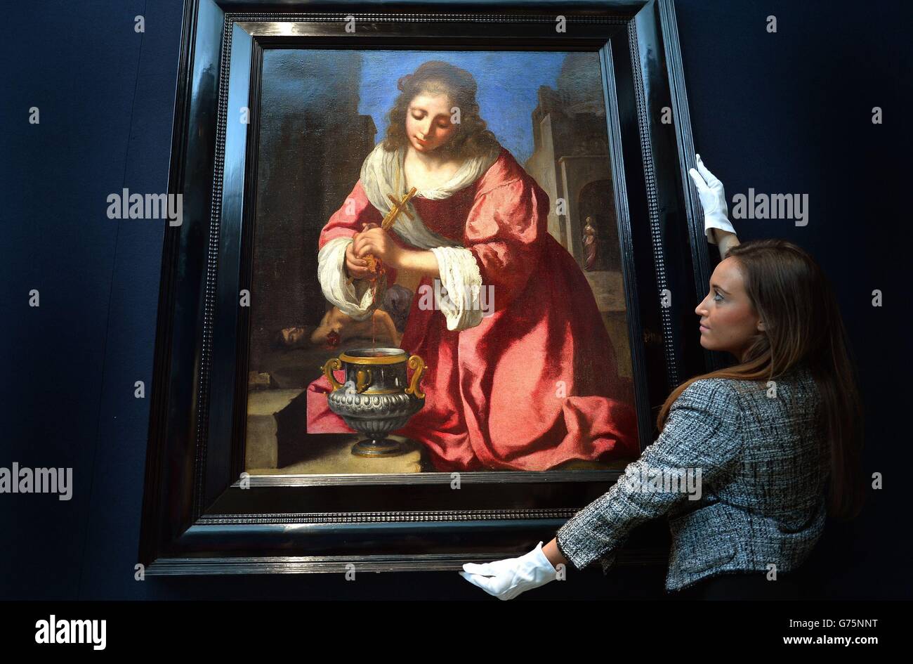 Un membre du personnel de Christie regarde un portrait de Saint Praxedis par Johannes Vermeer qui sera mis aux enchères dans le cadre de l'ancien Maître et amp; vente de peintures britanniques à Christie's à Londres. Banque D'Images