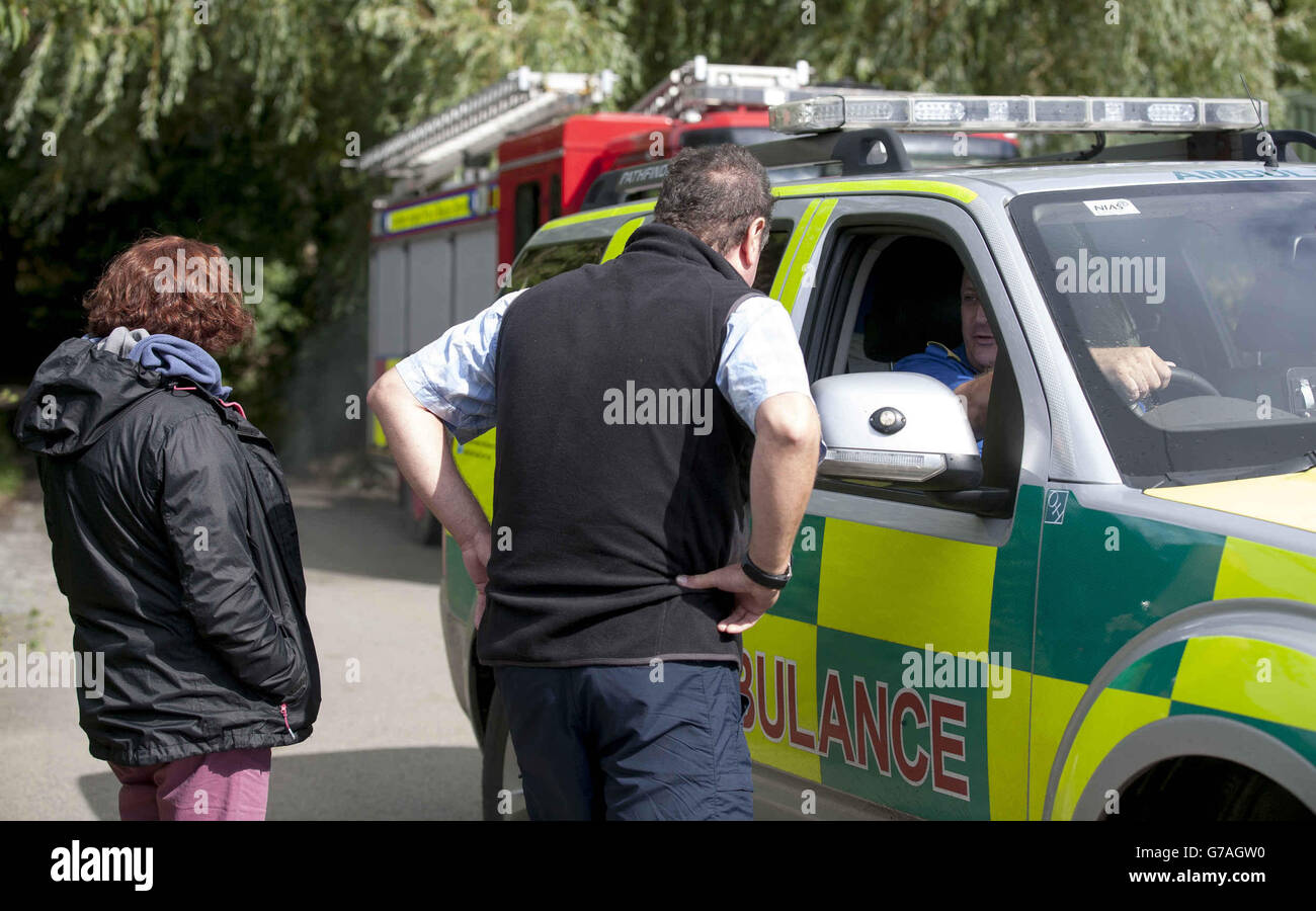 Des parents inquiets parlent avec un membre du service d'ambulance au East Down Yacht Club, à Killyleagh, en Irlande du Nord, après dix marins où un blessé après une régate en Irlande du Nord a été frappé par un calmar. Banque D'Images