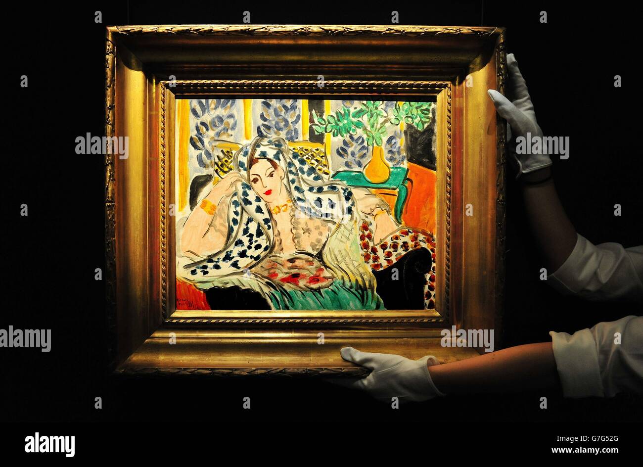 Freddi Privite, l'assistant de la galerie de Sotheby, ajuste l'Odalisque au Fauteuil Noir par Henri Matisse, avec une estimation de 9-12 millions de livres sterling, en avance sur la prochaine vente aux enchères de février 2015 impressionniste et d'Art moderne, dans le centre de Londres. Banque D'Images