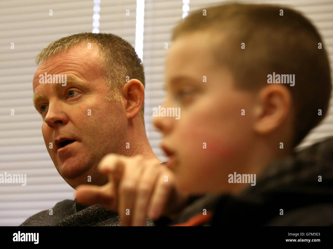 Kieran Duffy avec son père Robert au poste de police de London Road à Glasgow appel à l'information après que Kieran ait subi une blessure à la tête pendant le trajet vers le match Celtic v Rangers dimanche dernier. Banque D'Images