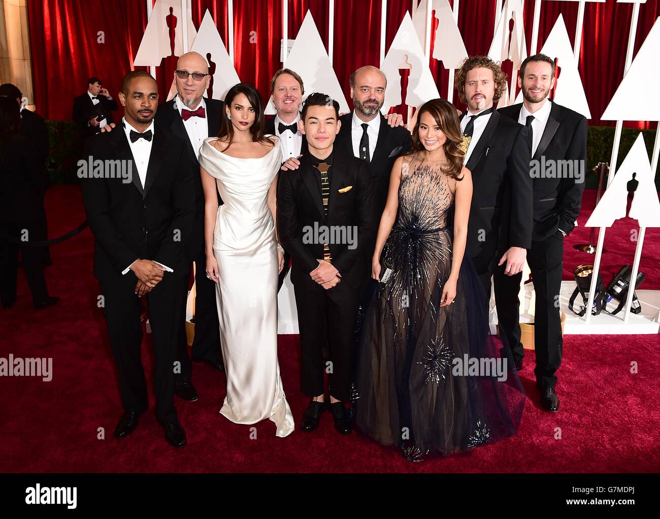 Jamie Chung, Genesis Rodriguez avec les producteurs et directeurs de Big Hero 6 arrivant aux 87e Academy Awards qui se tiennent au Dolby Theatre à Hollywood, Los Angeles, CA, Etats-Unis, le 22 février,2015. Banque D'Images