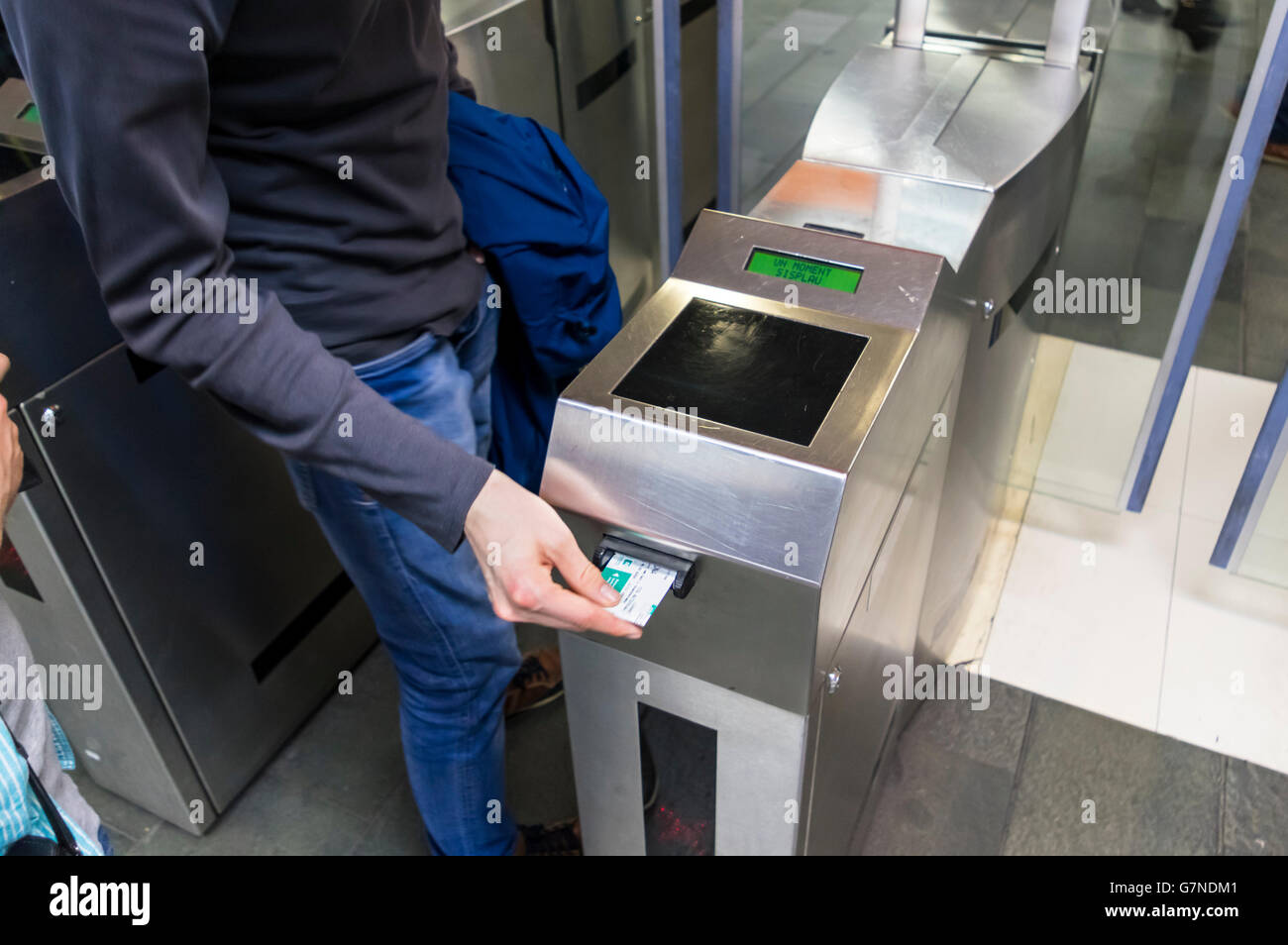 L'homme l'insertion d'un billet dans un billet contrôle de machine pour obtenir l'accès au système de métro de Barcelone. Banque D'Images
