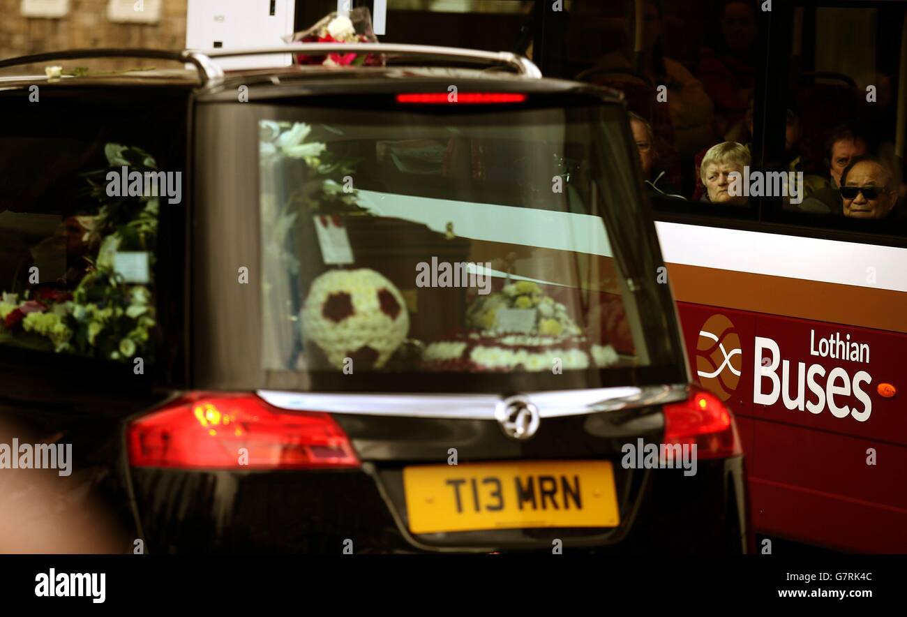 Les passagers dans un bus regardent que l'Hearse portant le cercueil de Dave Mackay quitte le stade Tynecastle pour ses funérailles au Mansfield Traquair Centre à Édimbourg. Banque D'Images