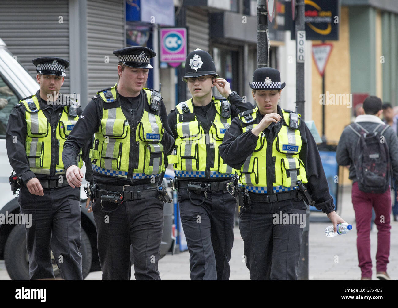 Quatre agents de la police britannique des transports patrouillent dans la rue à Highbury, à Londres. Banque D'Images