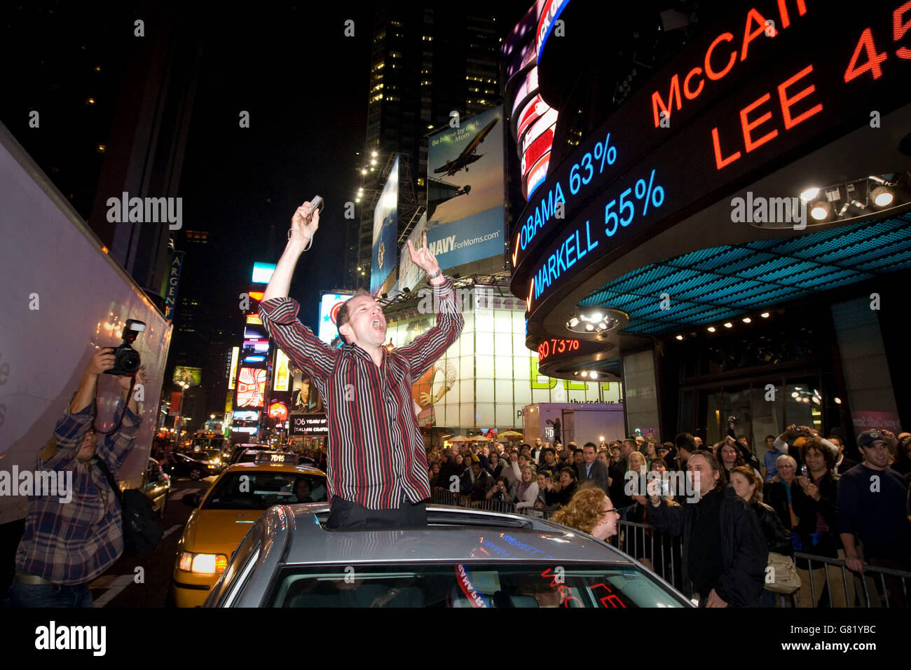 Les gens célèbrent sur Times Square à New York, NY, United States, après avoir regardé la couverture télévisuelle de la victoire de Barack Obama en Banque D'Images