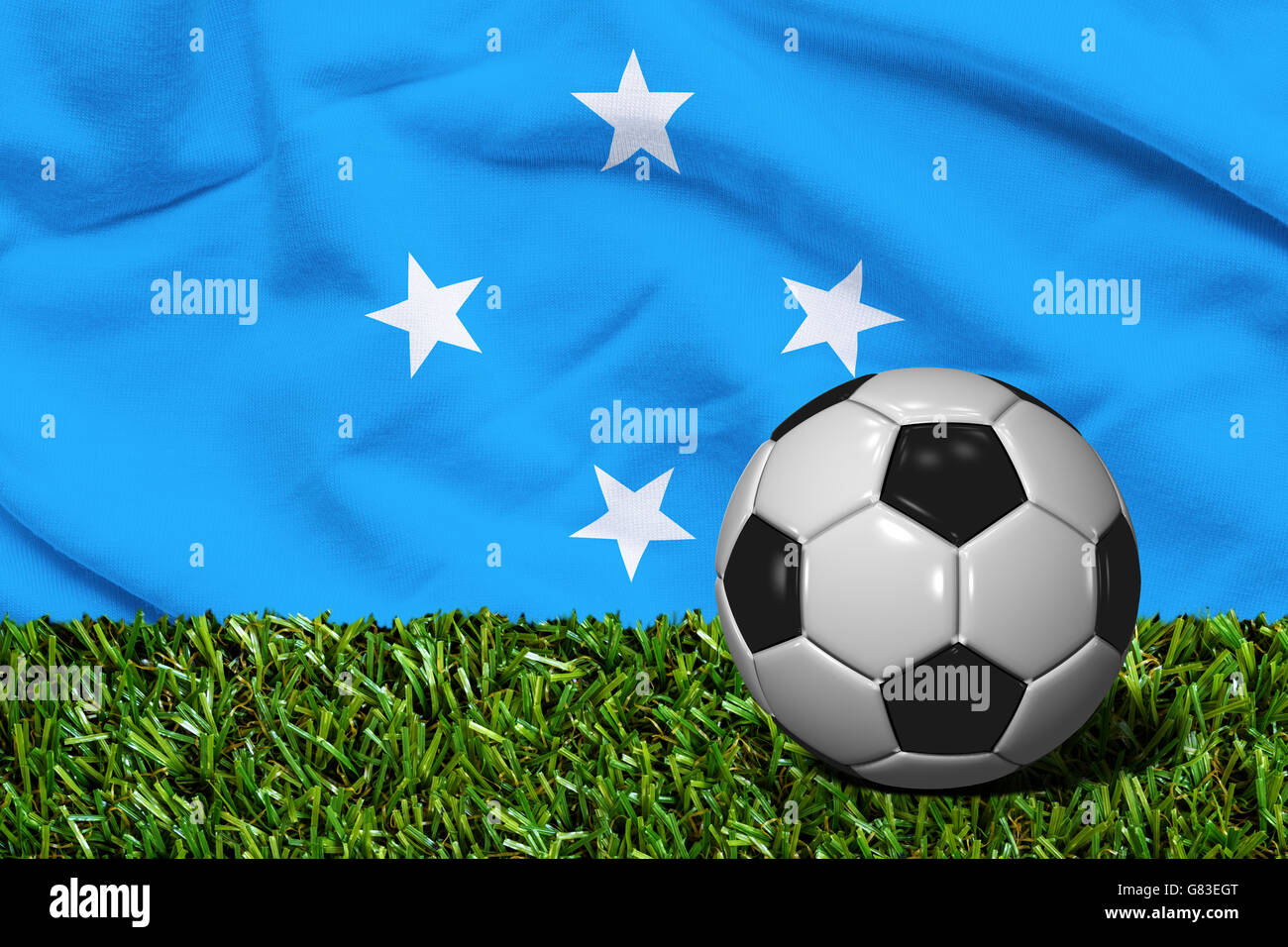 Ballon de soccer en rendu 3D dans le domaine de l'herbe avec drapeau Micronésie comme arrière-plan Banque D'Images