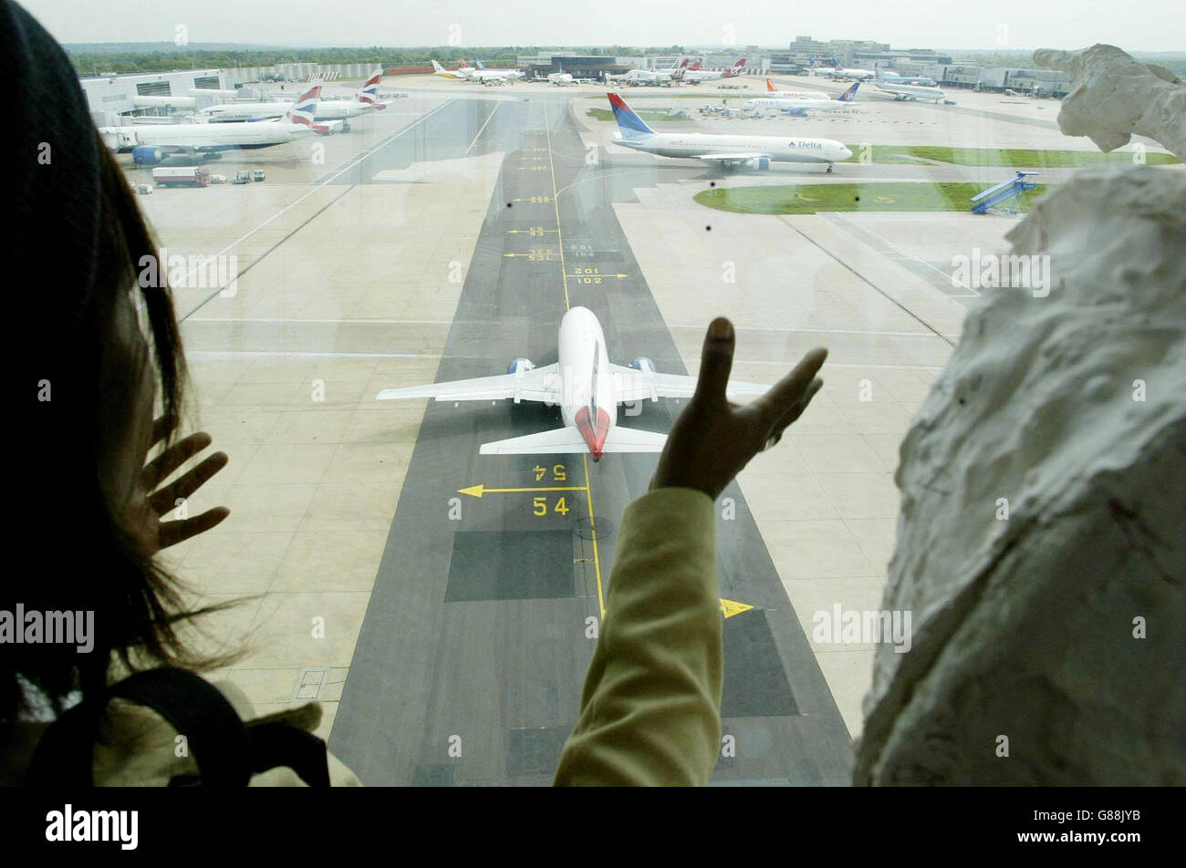 Un avion passe sous le plus grand pont de passagers aériens du monde le jour de son ouverture officielle. Banque D'Images