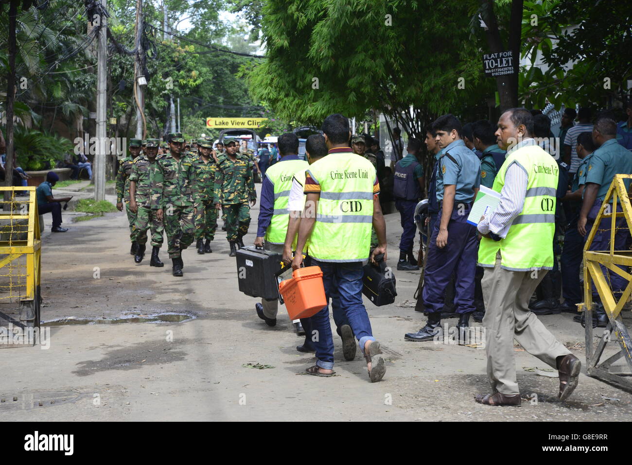 Les soldats et la police bangladaise à pied le long d'une rue menant à un restaurant de luxe à Dhaka le 2 juillet 2016, à la suite d'un siège sanglant là par des attaquants armés qui ont commencé le 1er juillet. Des militants lourdement armés ont assassiné 20 otages au Bangladesh, le hacking beaucoup de leurs victimes à la mort, avant que six des assaillants ont été abattus à la fin d'un siège le 2 juillet dans un restaurant rempli d'étrangers. Comme l'État islamique (Est) le groupe a revendiqué la responsabilité de ce carnage au début de la maison de l'Eid, Premier Ministre Sheikh Hasina a dit qu'elle était déterminée à éradiquer l'activisme musulman principalement na Banque D'Images