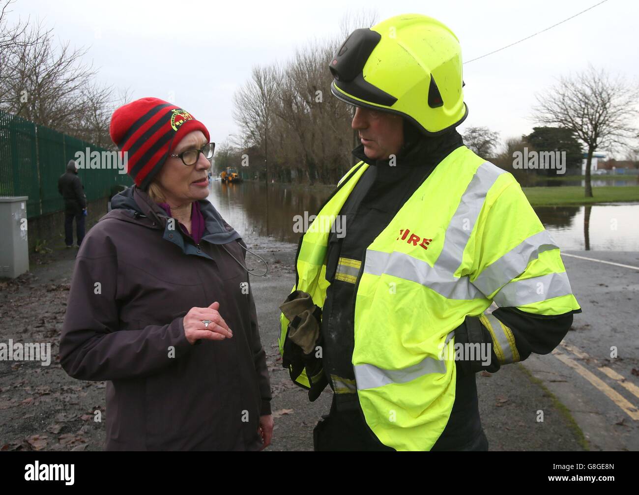 Le ministre de l'éducation, Jan O'Sullivan, est informé par le pompier Denis King, dans la région de Corbally, à Limerick, en Irlande, alors que les inondations se poursuivent le long des rives de la rivière Shannon. Banque D'Images