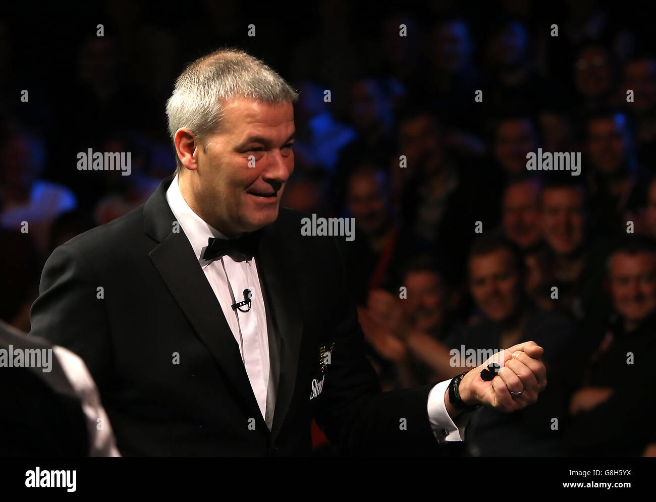 L'arbitre Jan Verhaas enlève un papillon qui a atterri sur la table pendant le match entre John Higgins et Neil Robertson pendant le dixième jour du championnat britannique de Snooker de Betway 2015 au York Barbican, York. Banque D'Images