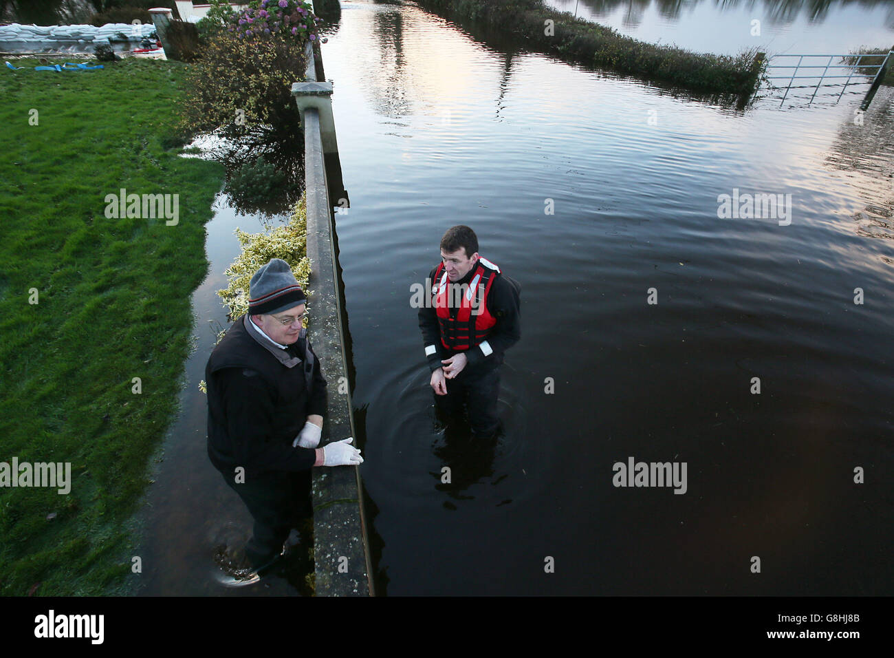 L'homme local John Mason (à gauche) parle à Aiden Webster, des ingénieurs de l'armée irlandaise près de Springfield, comté de Clare, car les inondations vont s'aggraver au cours du week-end. Banque D'Images