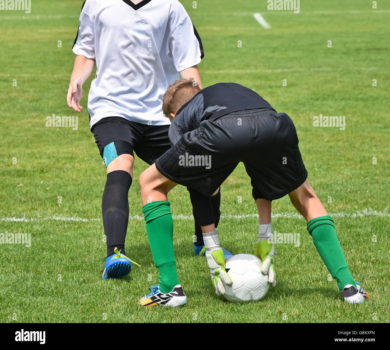 Gardien de but avec une balle au match de foot Banque D'Images