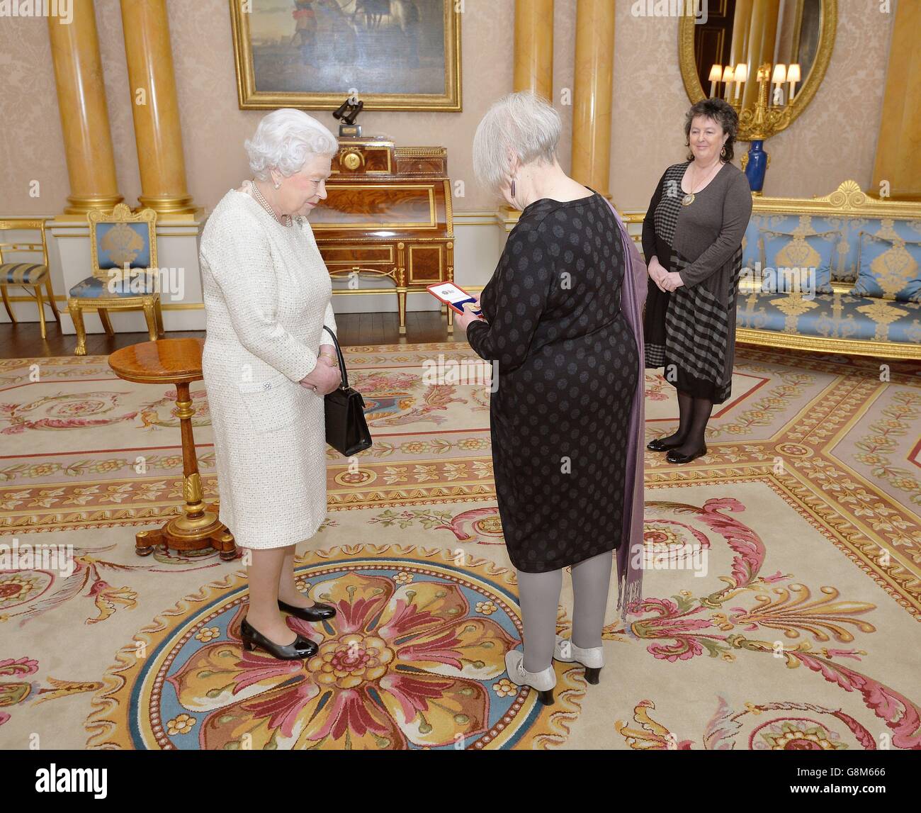 La reine Elizabeth II avec Liz Lochhead après l'avoir presentée avec la Médaille d'or de la reine pour la poésie, accompagnée de la professeure Dame Carol Ann Duffy, lauréate du poète, lors d'une audience privée, au Palais de Buckingham, dans le centre de Londres à Westminster. Banque D'Images