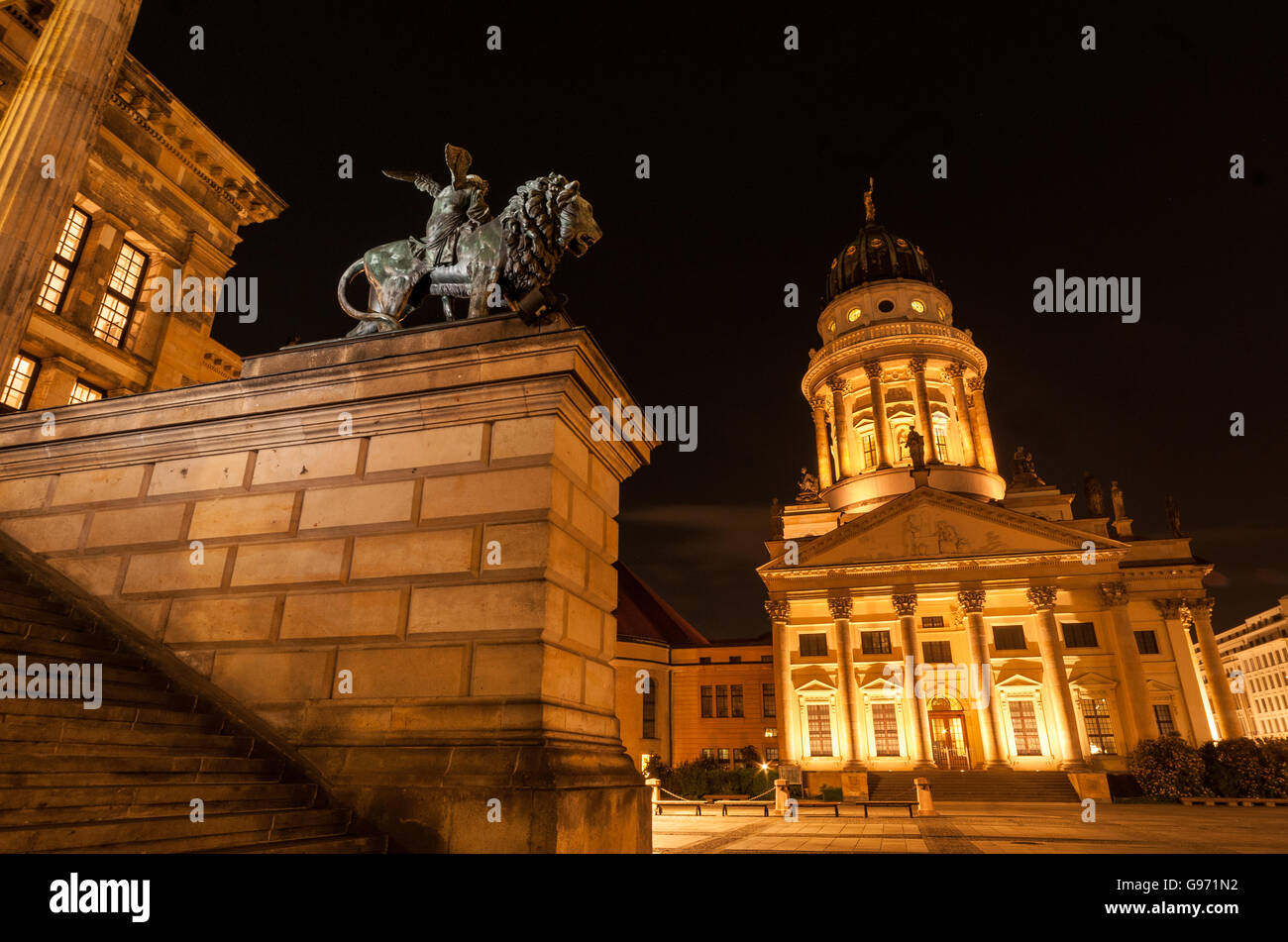 Statue en bronze d'un lion et Französischer Dom (l'Eglise de France), du Gendarmenmarkt, Berlin, tourné pendant la nuit. Banque D'Images