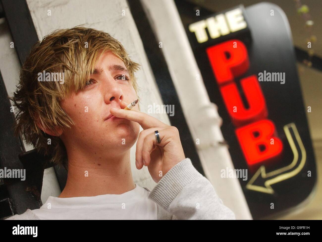 Pose de la photographie de Stephen Clarke, 19 ans, fumer à l'extérieur du Pub sur Ashton Lane à Glasgow. Les ventes de boissons ont chuté de plus de 10 % depuis l'entrée en vigueur de l'interdiction de fumer dans les lieux publics en Écosse, ont déclaré aujourd'hui les patrons de pub. Banque D'Images