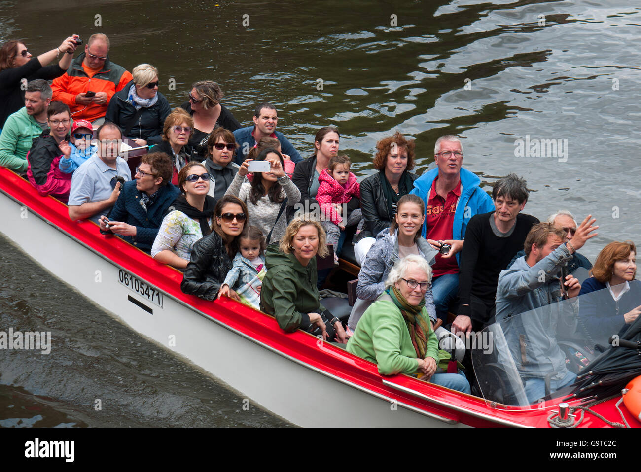 Les touristes profitant d'une excursion en bateau sur les canaux de Bruges en Belgique. Banque D'Images