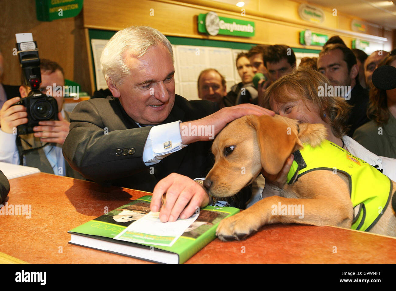 Taoiseach Bertie Ahern (au centre) place un pari de charité de 1000 euros, pour les chiens guides irlandais pour les aveugles, avec le bookmaker Paddy Power, à la cote de 8/1 pour être retourné comme chef de gouvernement après les prochaines élections générales. Banque D'Images