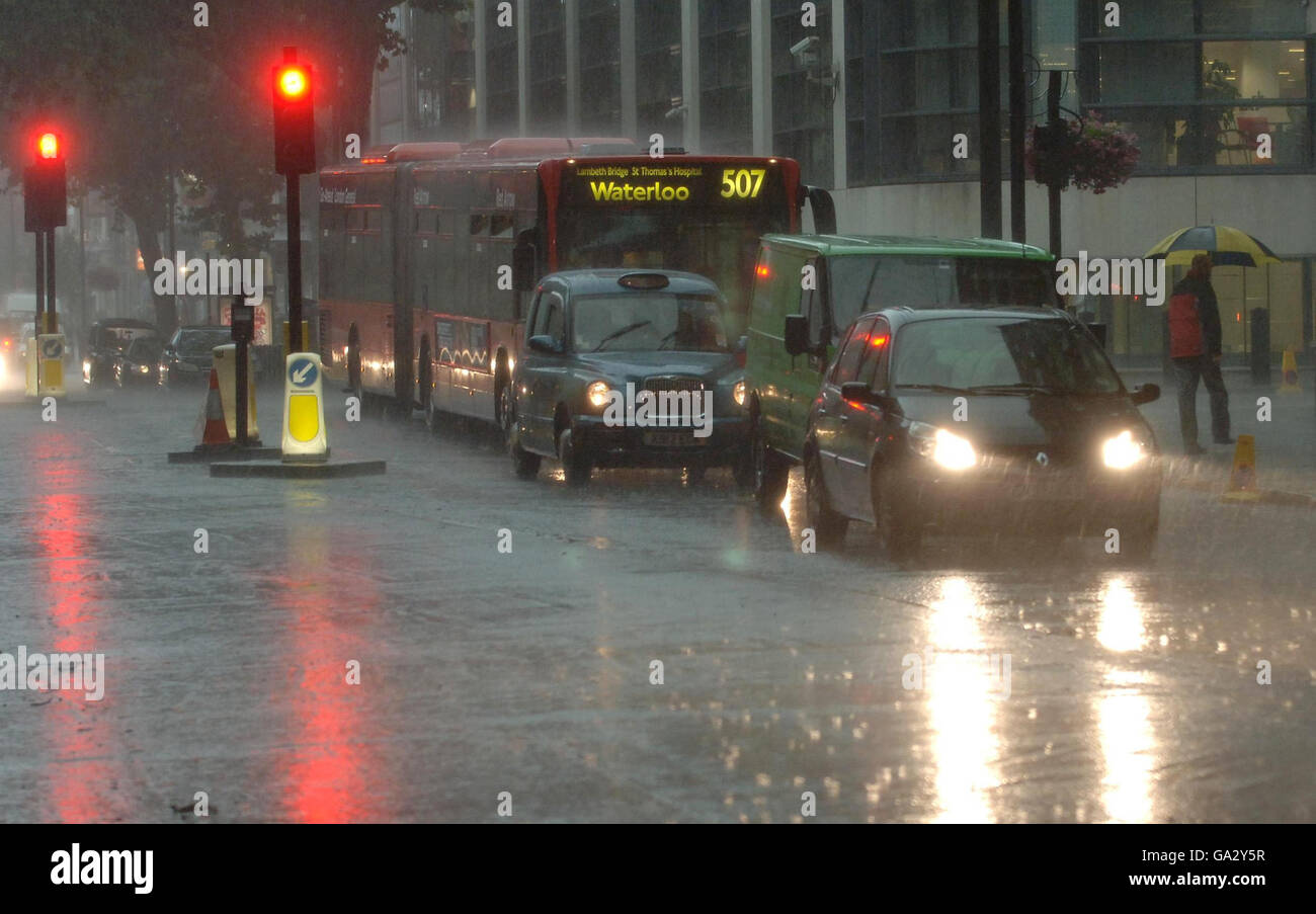 La circulation à mi-journée vous permet de traverser la pluie torrentielle du centre de Londres aujourd'hui. Banque D'Images