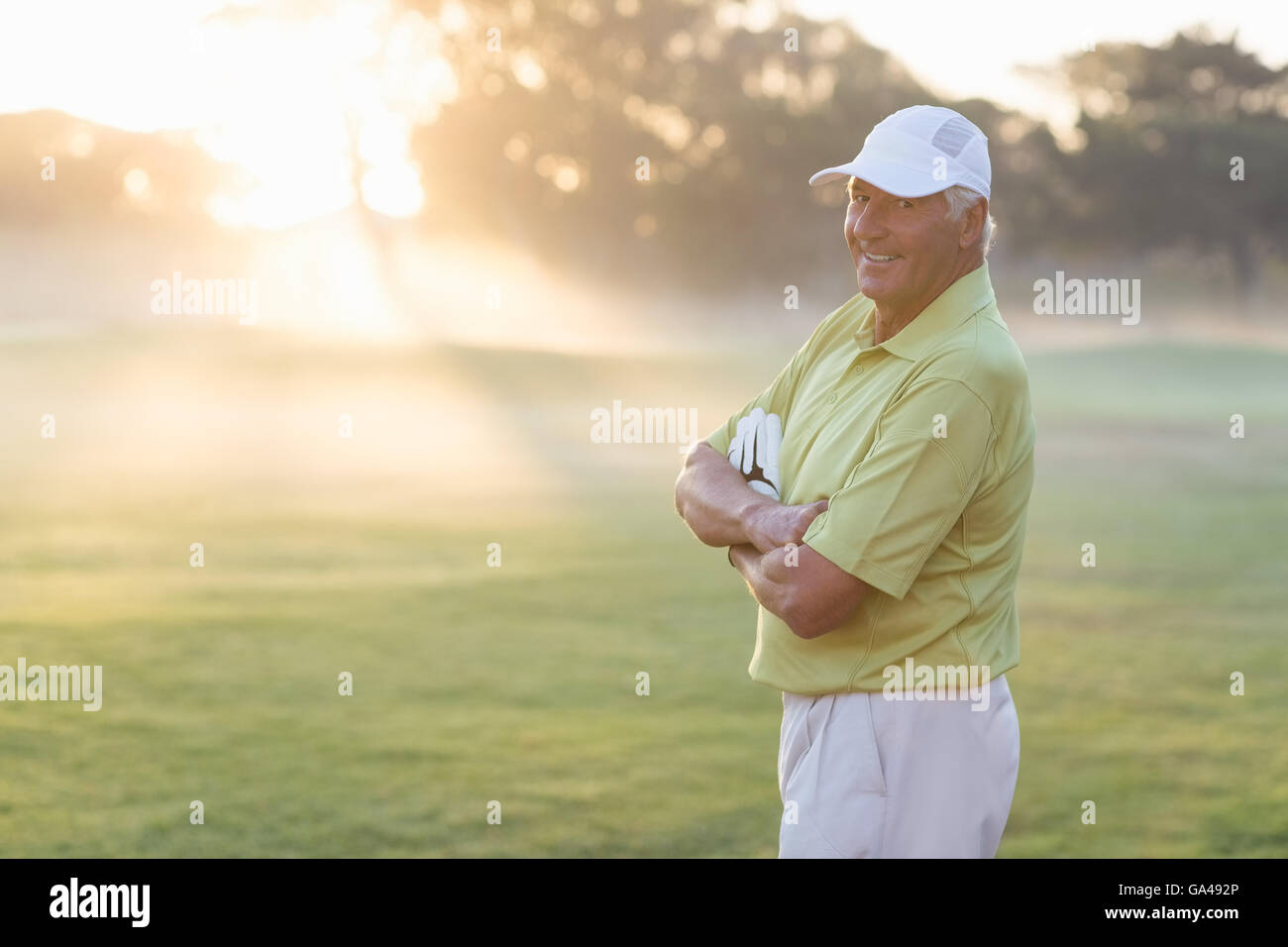 Portrait of happy golfer with arms crossed Banque D'Images