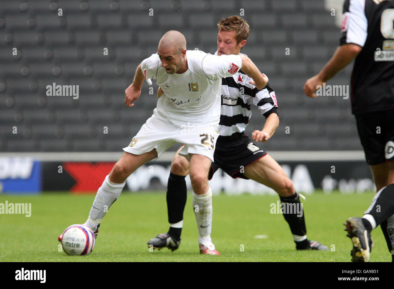 Danny Swailes de Milton Keynes lutte contre Ian Miller de Darlington (à droite) lors du match de la Coca-Cola football League Two au stade :mk, Milton Keynes. Banque D'Images