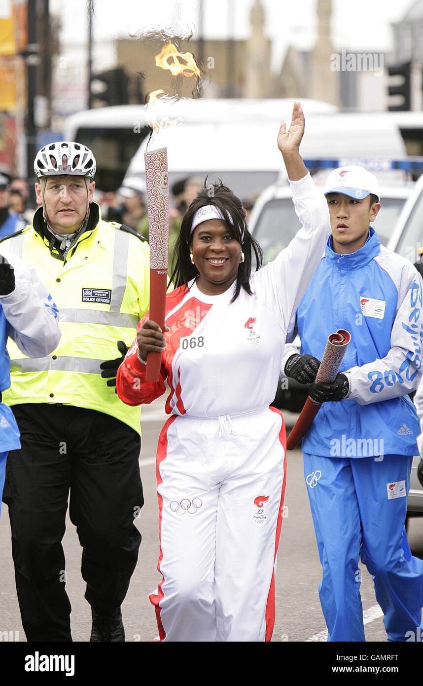 Tessa Sanderson porte le flambeau de Stratford pendant la Beijing Relais de la torche olympique à Londres Banque D'Images