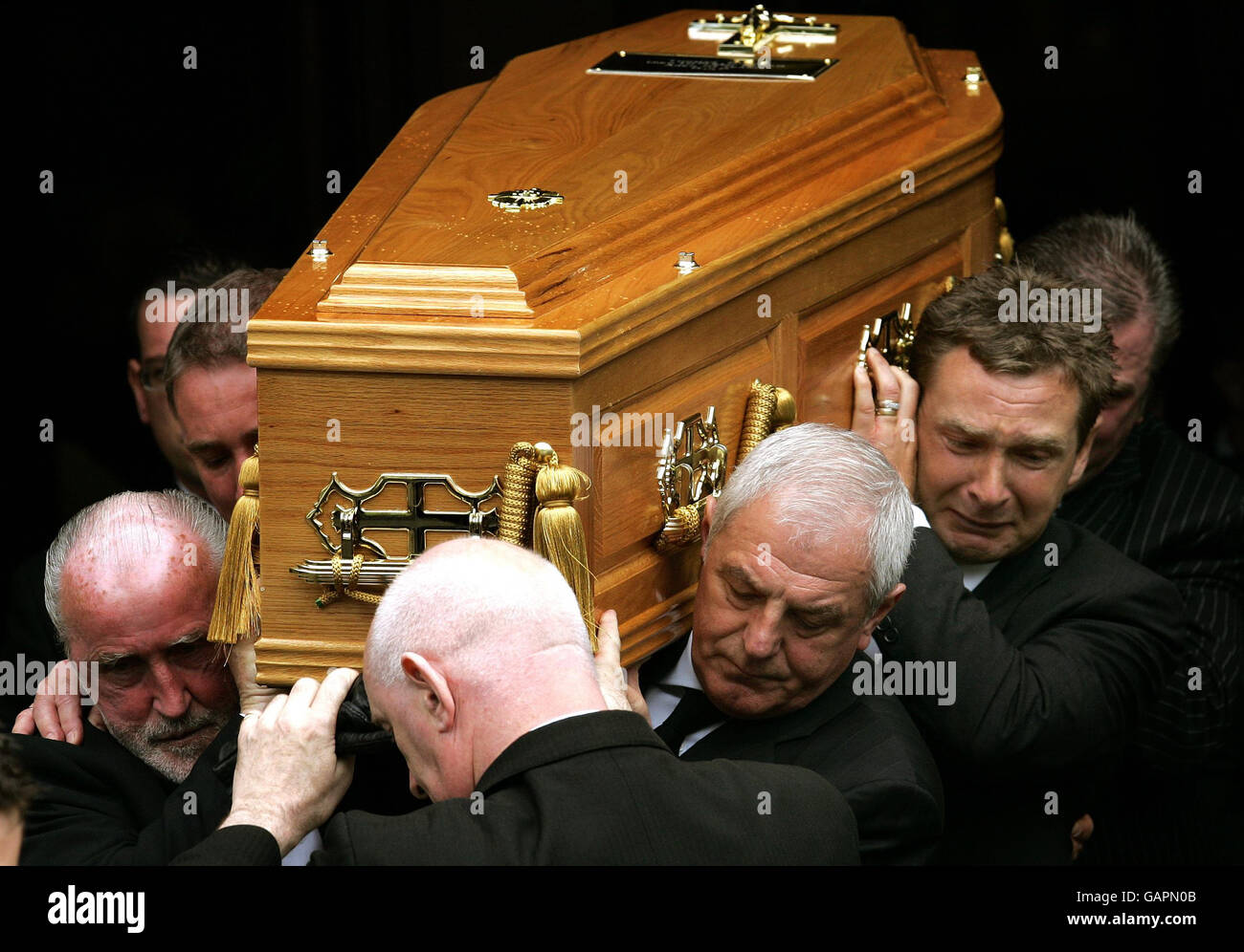 Walter Smith, directeur des Glasgow Rangers (deuxième à droite), porte le cercueil de Tommy Burns avec Peter Grant (à droite) et Danny McGrain (à gauche), anciens coéquipiers de Burn, après les funérailles à l'église St Mary's Church, à Glasgow. Banque D'Images