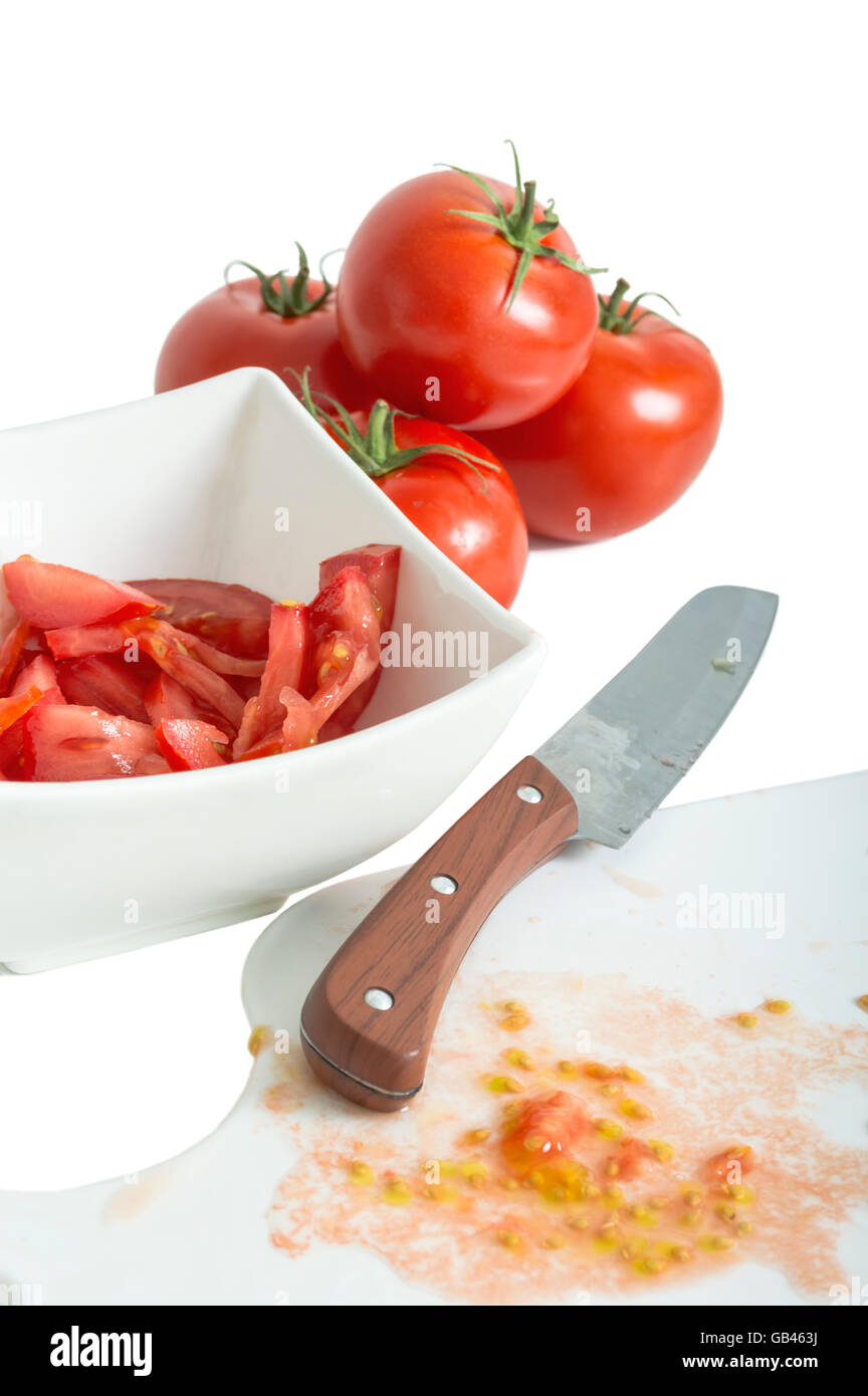 Les tomates hachées et le couteau sur une planche à découper. focus sélectif. Banque D'Images