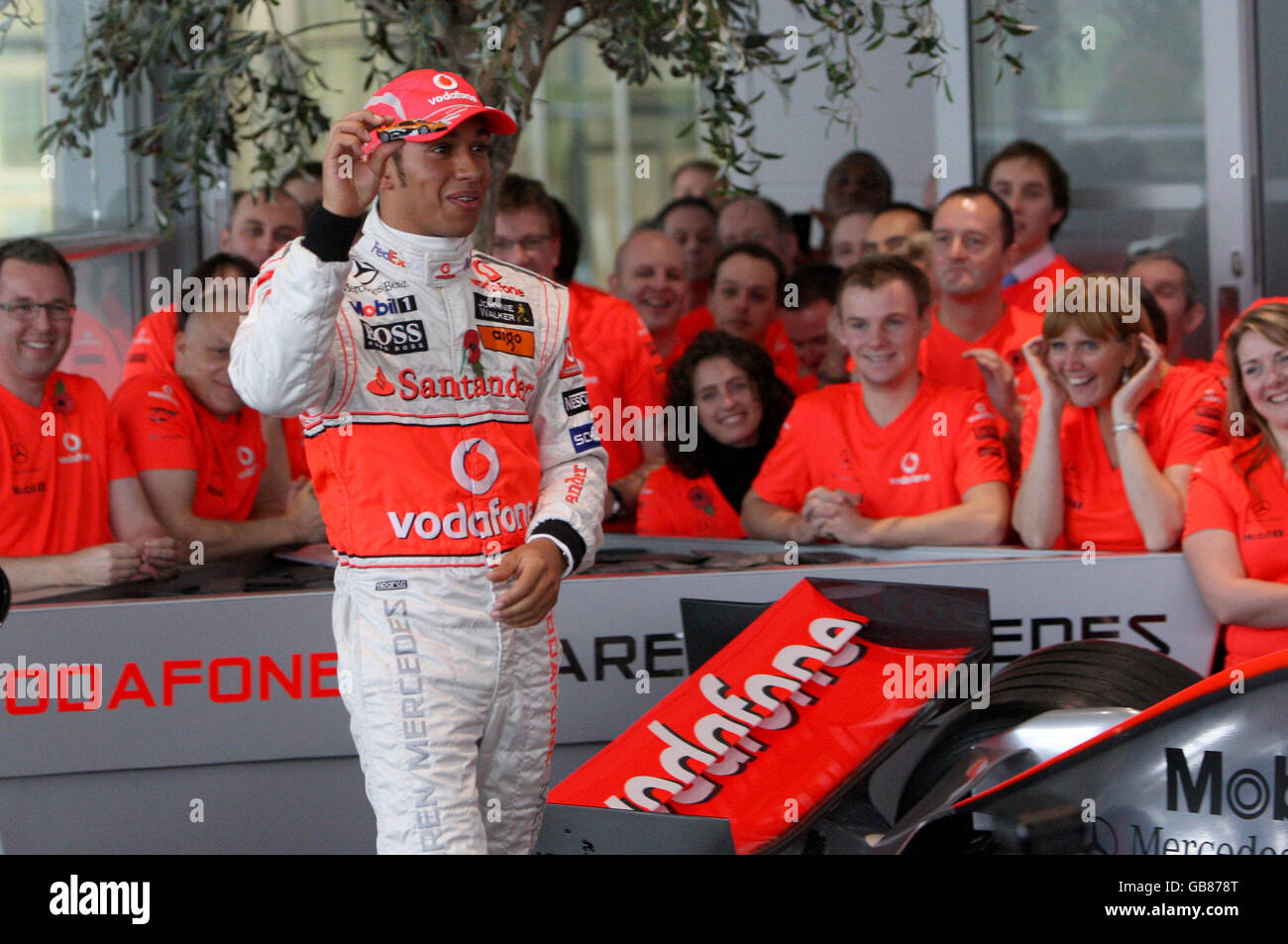 Lewis Hamilton, champion du monde de Formule 1 en Grande-Bretagne, regarde un modèle d'un McClaren F1LM qui lui a été donné par Ron Dennis (non représenté) lorsqu'il revient au siège de McLaren à Woking. Banque D'Images