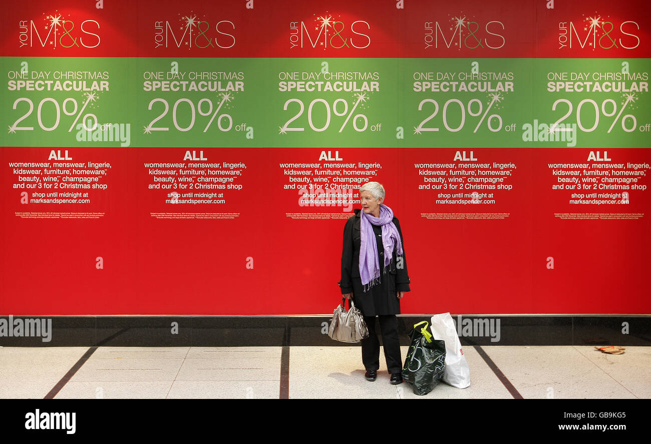 Ventes de grande rue.Les clients se prominent devant les panneaux de vente à la fenêtre d'une succursale de Marks & Spencer sur Oxford Street, Londres. Banque D'Images