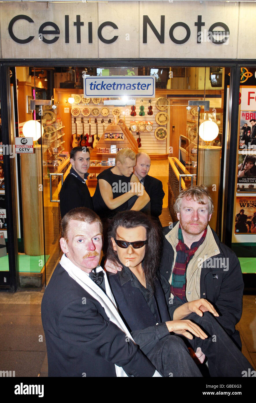 Fans de U2 (avant L-R) Vincent Kearn, Martin Shanahan et arrière (L-R) Colm O'Siochain et Donal Cassidy de Celtic Note portent des cire de Bono et Larry à l'extérieur du magasin sur Nassau Street, Dublin. Banque D'Images