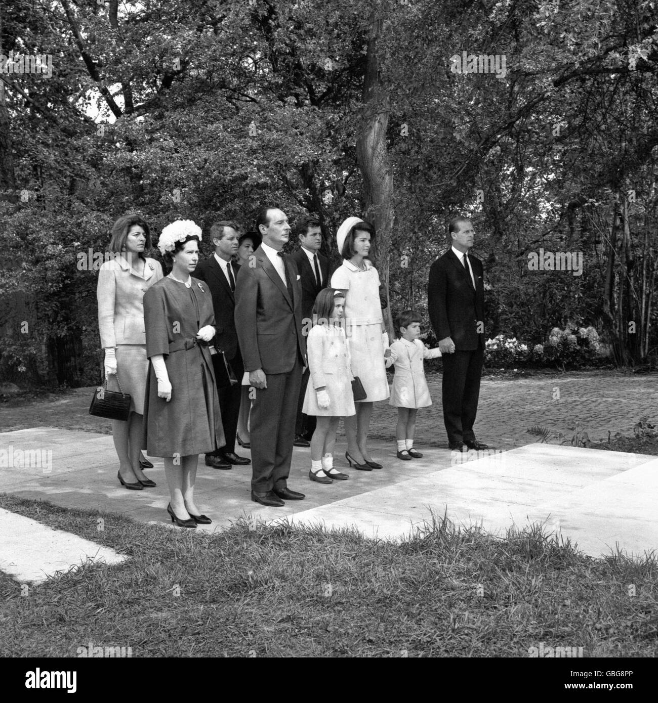 Caroline et John, les enfants du président John F Kennedy, dont la main est tenue par le duc d'Édimbourg, se tiennent en silence avec d'autres membres du parti avant le mémorial de leur père assassiné à Runnymede.De gauche à droite, au premier rang : la reine Elizabeth II, qui a inauguré le Mémorial, Lord Harlech, président des fiduciaires du Mémorial Kennedy, Caroline Kennedy, Jacqueline Kennedy, John Kennedy, duc d'Édimbourg.Rangée arrière; Patricia Lawford Kennedy, sénateur Robert Kennedy, Joan Bennett Kennedy et son mari, sénateur Edward Kennedy. Banque D'Images
