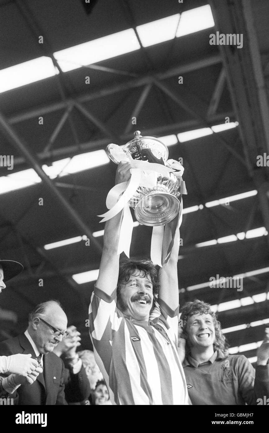 Bobby Kerr, capitaine de Sunderland, lève la coupe FA après son La victoire de l'équipe en 1-0 en tant que gardien de but Jim Montgomery applaudit avec enthousiasme Banque D'Images