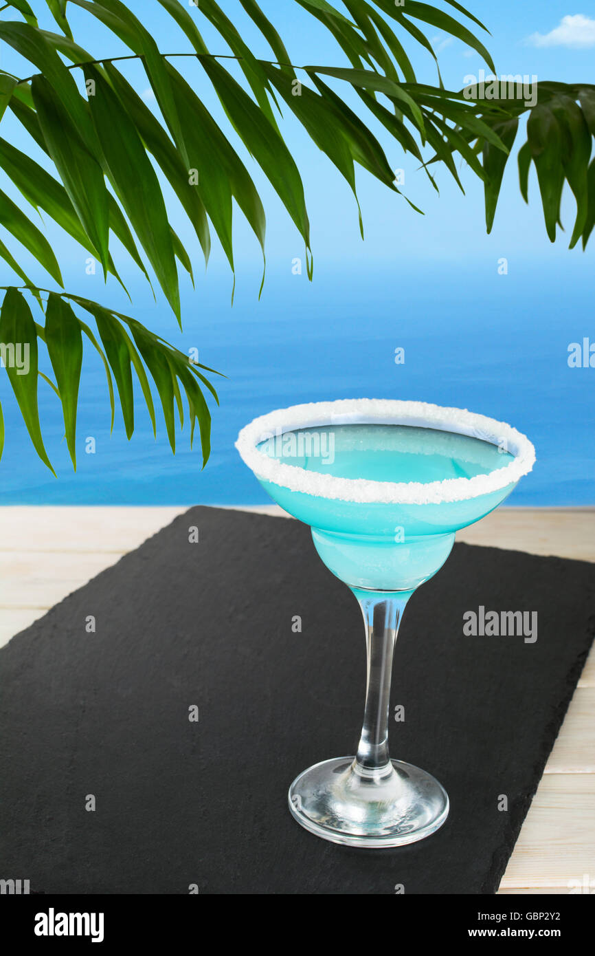 Blue cocktail sur la plage tropicale. Margarita Blue Lagoon cocktail martini. Plage d'été boire de l'alcool. Bleu glacé cosmopolitan Banque D'Images