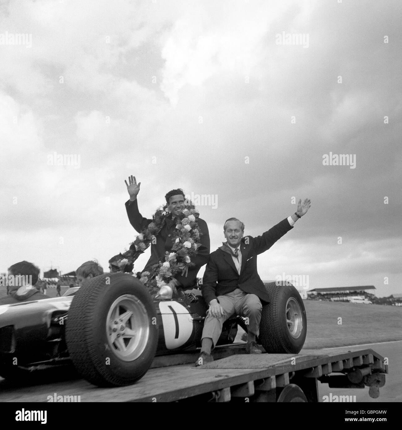Jim Clark (l) célèbre avec le chef de Lotus Colin Chapman après avoir remporté le Grand Prix britannique à Brands Hatch cet après-midi. L'événement a également été désigné Grand Prix d'Europe Banque D'Images