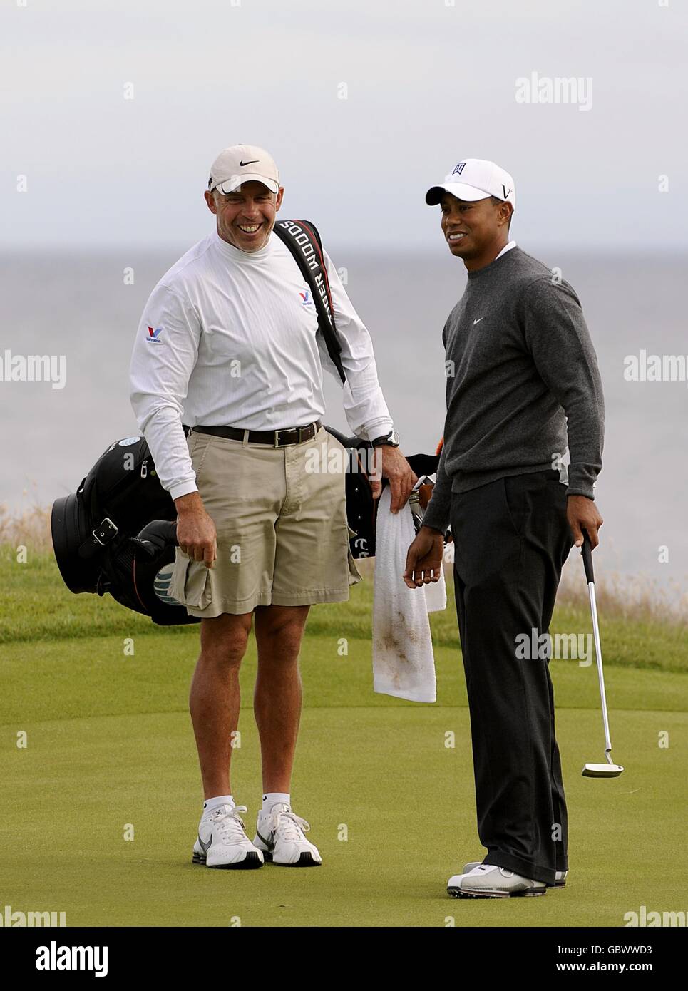USA Tiger Woods (à droite) partage une blague avec son caddie Pendant la troisième journée d'entraînement au Turnberry Golf Club Banque D'Images