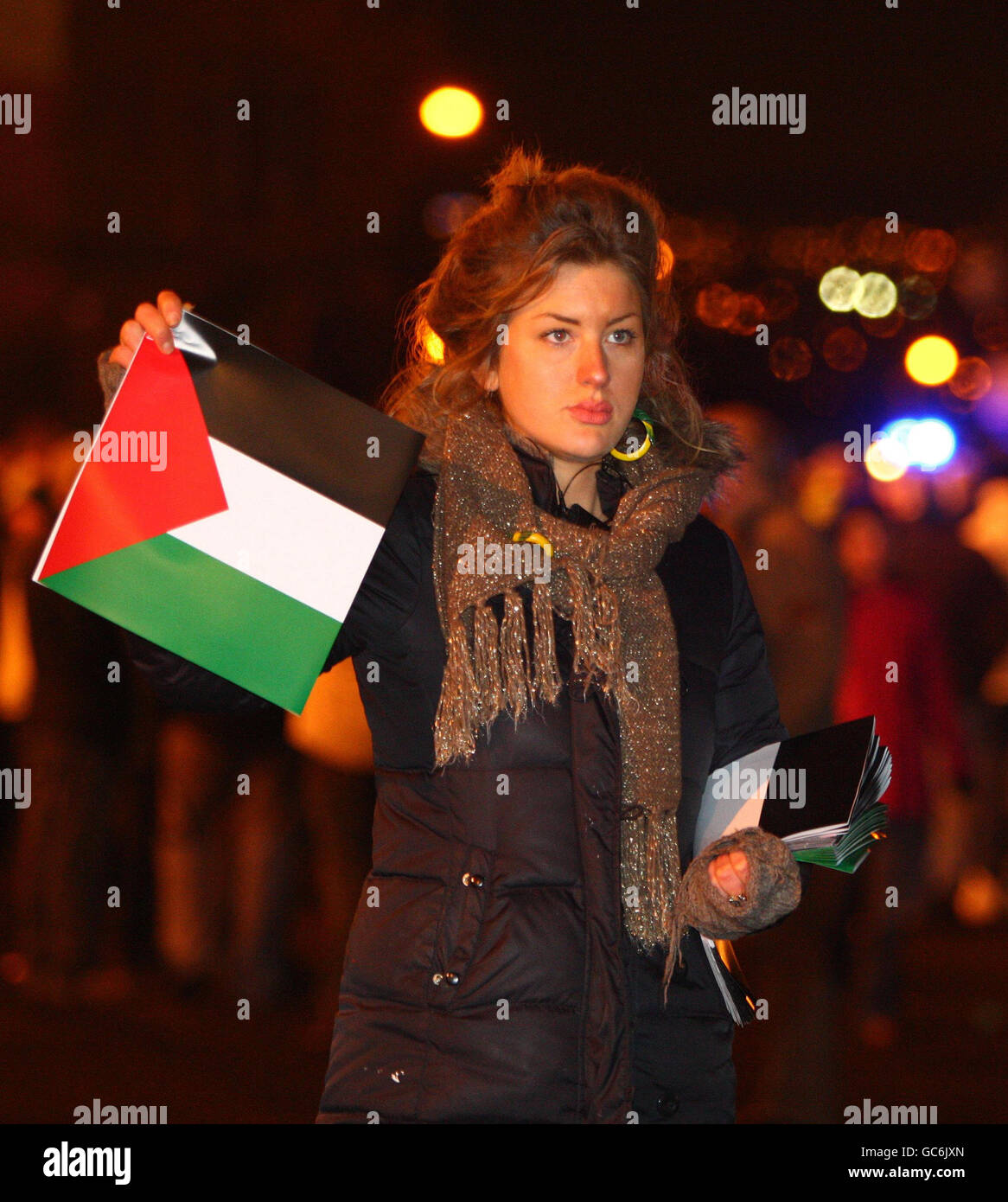 Une femme remet des drapeaux de Palestine aux fans alors qu'ils arrivent pour le match de l'Europa League au Celtic Park, Glasgow. Banque D'Images