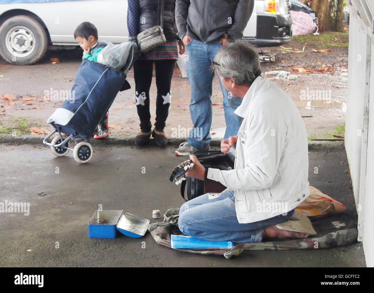 Street musician playing pour une famille Banque D'Images