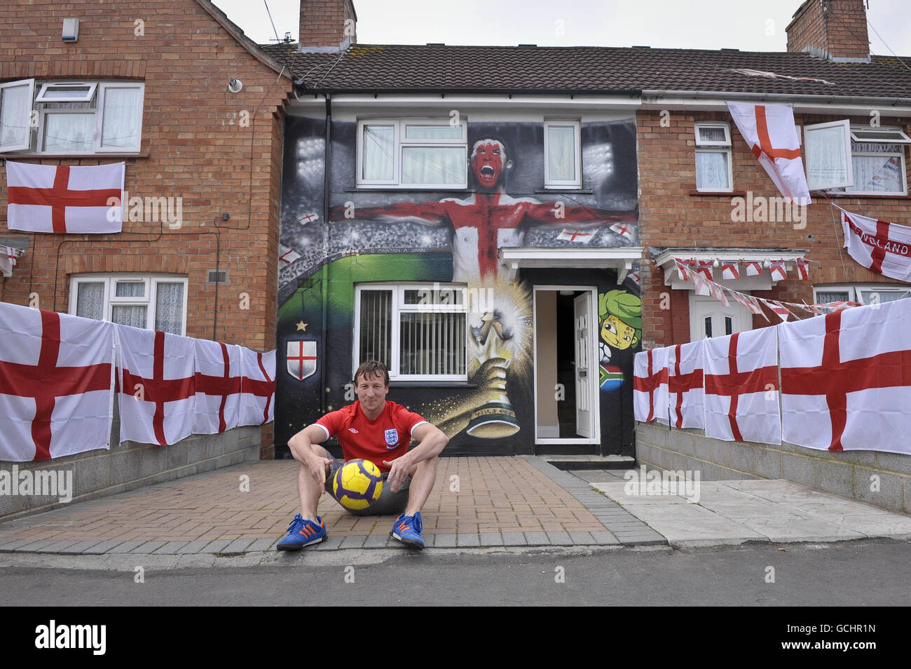 Lee Bray, 34 ans, fan de football d'Angleterre, de Knowle West, Bristol, devant sa maison sur le thème de la coupe du monde qui a été vaporisée par des artistes locaux du graffiti. Banque D'Images