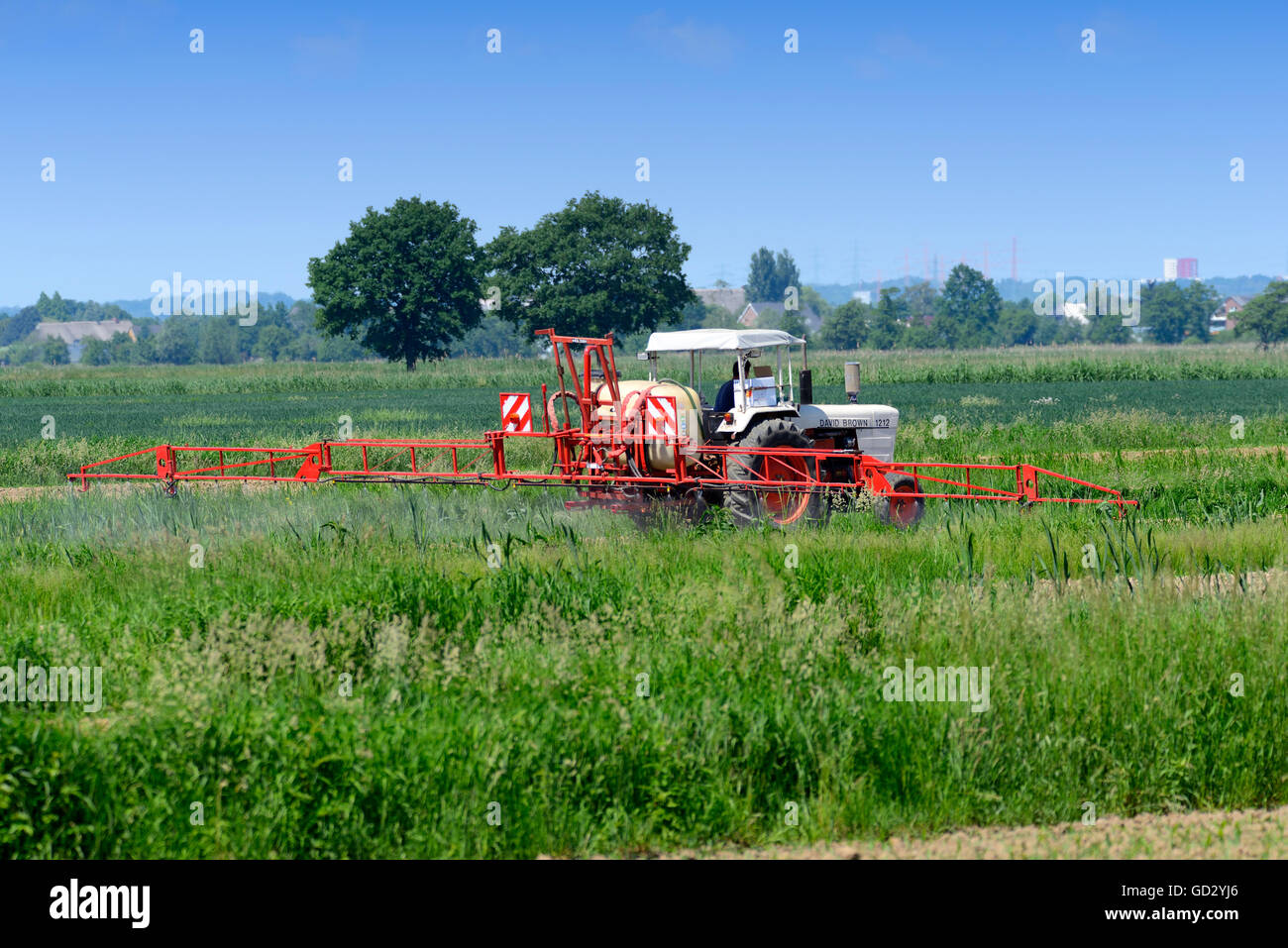 Le tracteur la pulvérisation de pesticides sur un champ Banque D'Images