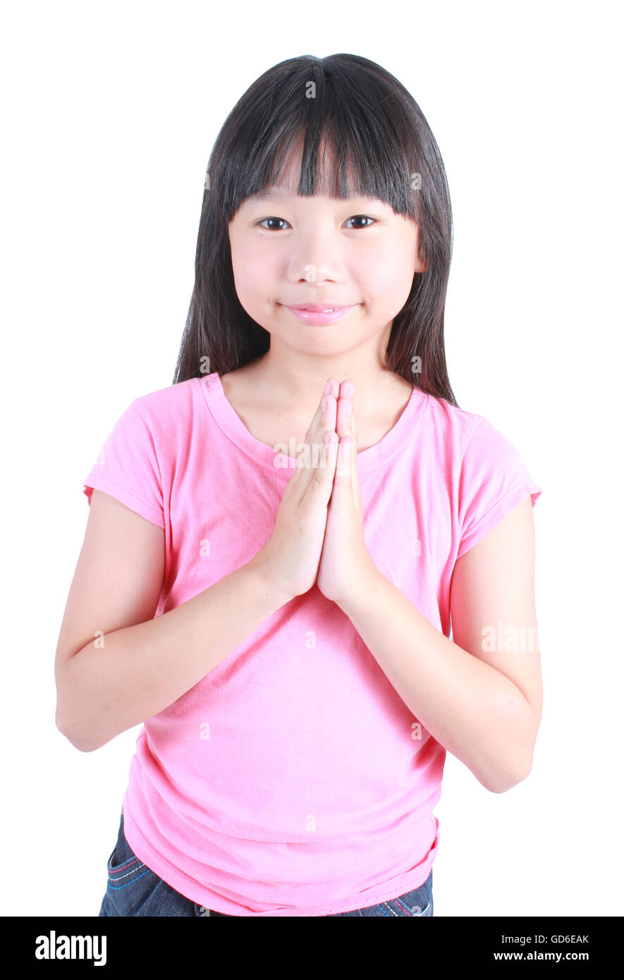 Jeune fille asiatique mit ses mains ensemble et prier sur fond blanc. Banque D'Images