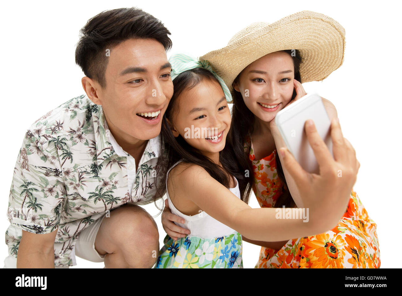 Une famille heureuse de trois à prendre le téléphone retardateur Banque D'Images