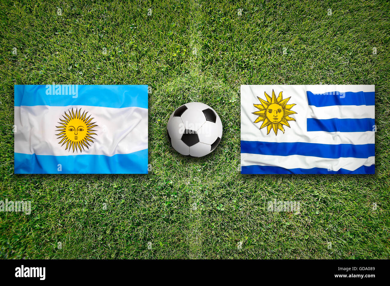 Brésil vs Uruguay Les drapeaux sur le terrain de soccer vert Banque D'Images