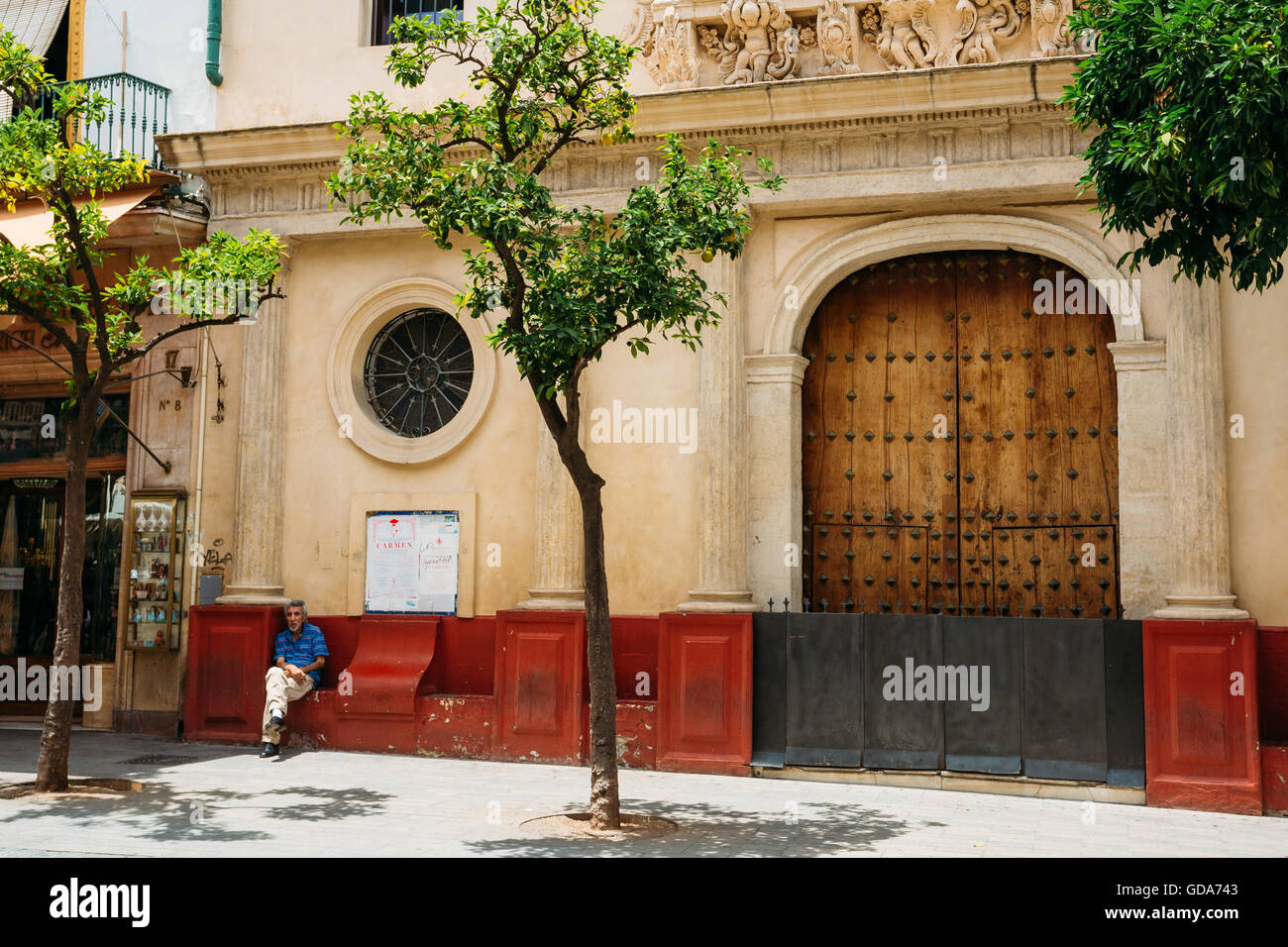 Séville, Espagne - 24 juin 2015 : Homme assis près de l'entrée à l'église à l'hôpital San Juan de Dios, sur la plaza del Salvador en Sevill Banque D'Images