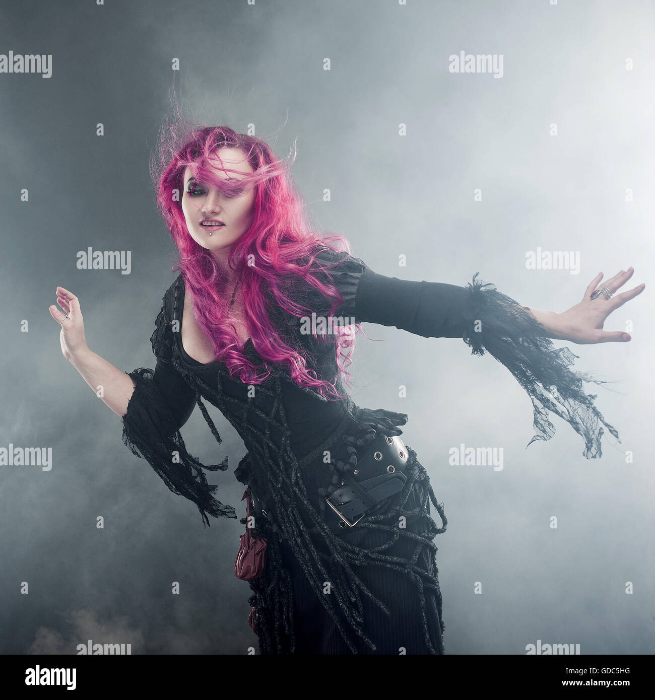 Sorcière Halloween crée la magie. Belle femme aux cheveux rouges en costume  de sorcière Photo Stock - Alamy