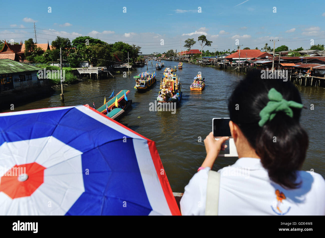 Nonthaburi. 16 juillet, 2016. Les gens regardent le canal parade marquant la Asalha Bucha Day à Bang Kruai de la province de Nonthaburi, dans le centre de la Thaïlande, le 16 juillet 2016. Asalha Bucha Day est une fête bouddhiste important observé sur un jour de pleine lune du huitième mois dans le calendrier thaïlandais pour marquer le premier sermon donné par le Bouddhisme Sakyamuni fondateur après son illumination. Mangmang Crédit : Li/Xinhua/Alamy Live News Banque D'Images