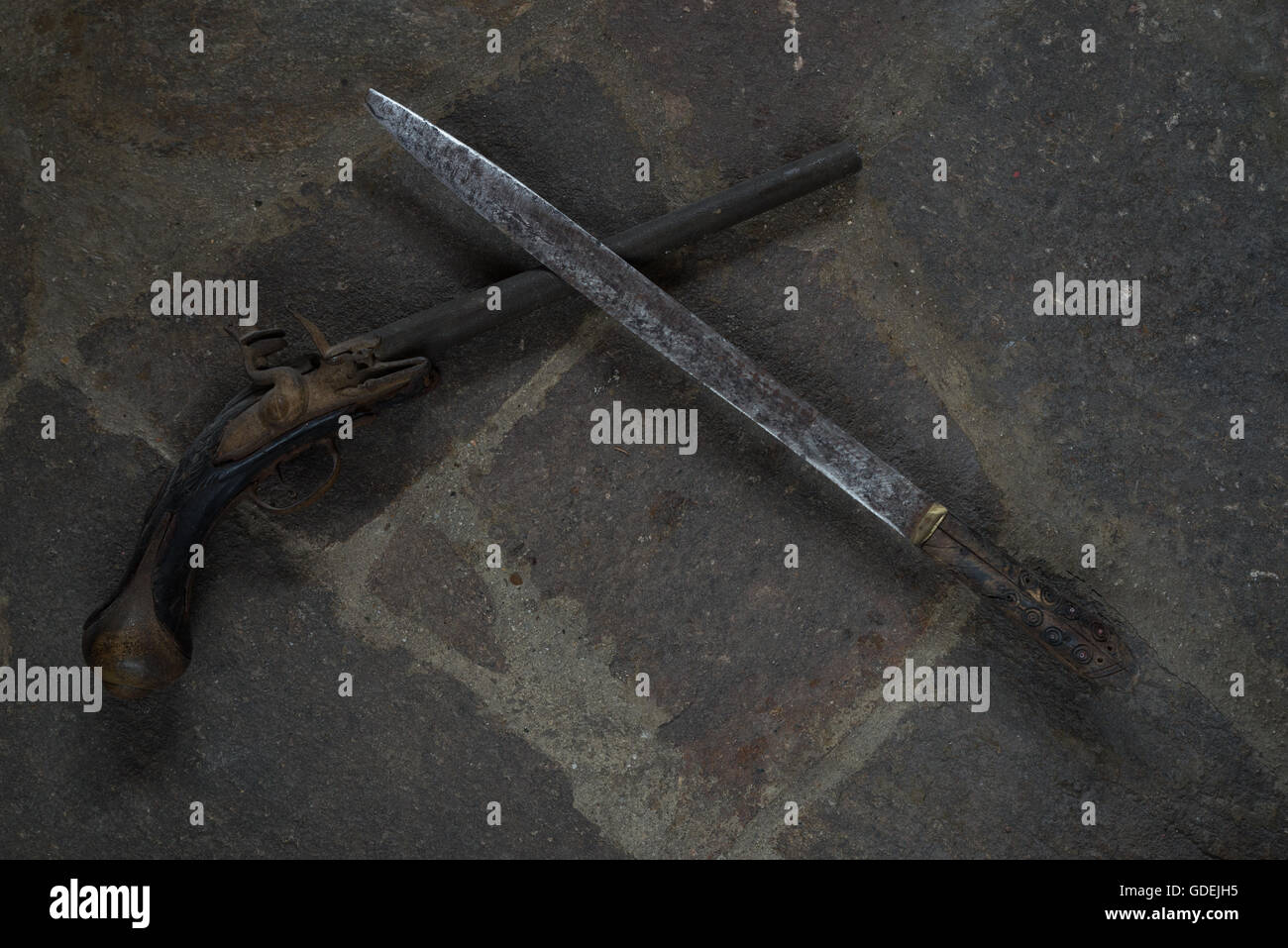 Armes à feu antiques et l'épée sur le sol en pierre Banque D'Images