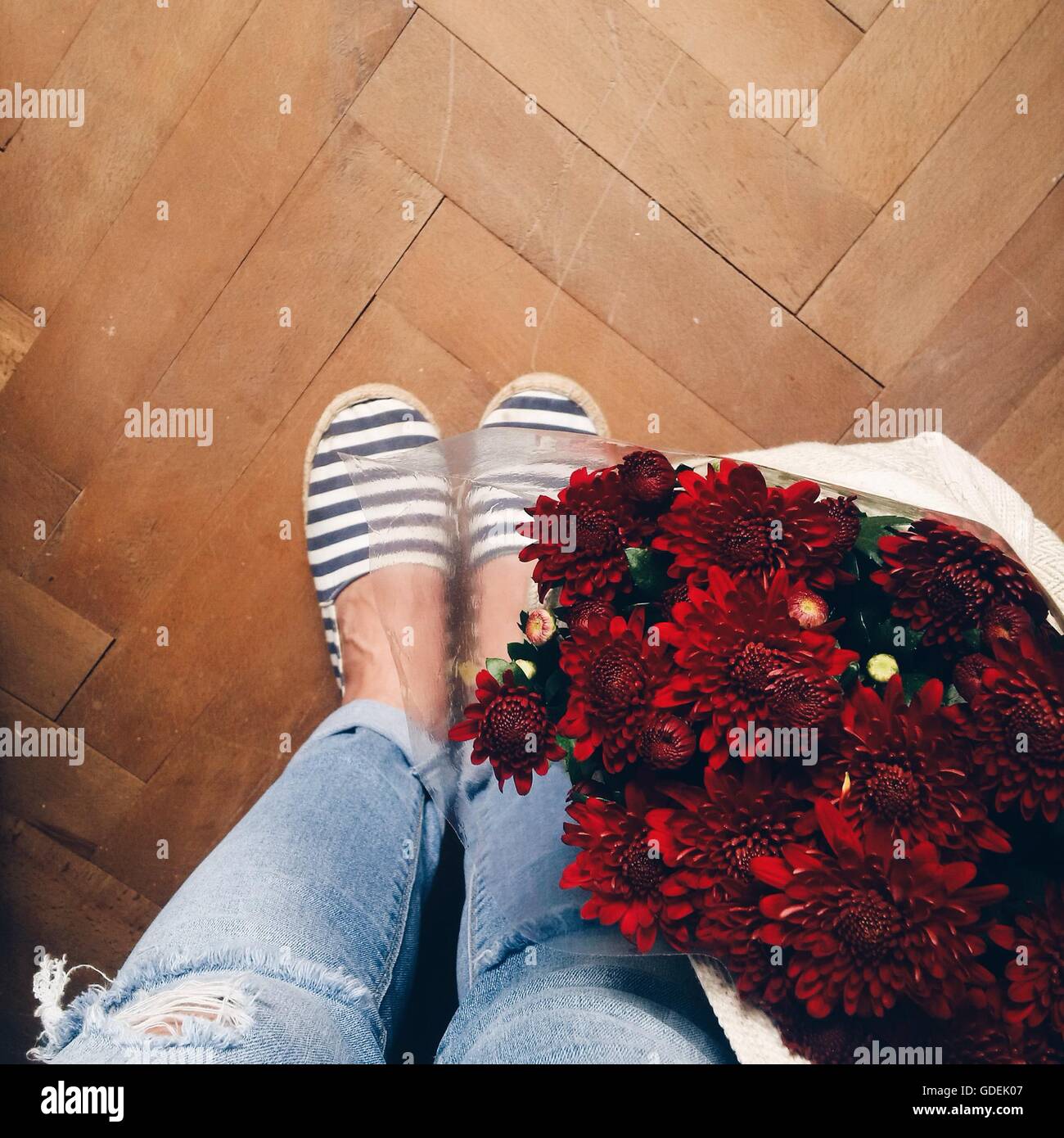 Les jambes de la femme et des fleurs dans un sac Banque D'Images